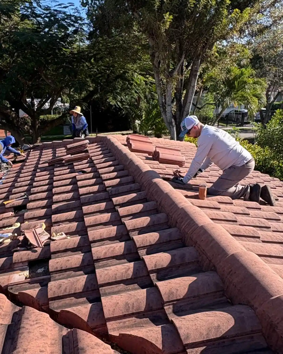 Weather Recovery Solutions performing a precision tile roof repair in The Roads neighborhood of Miami-Dade County, ensuring compliance with High-Velocity Hurricane Zone (HVHZ) standards.