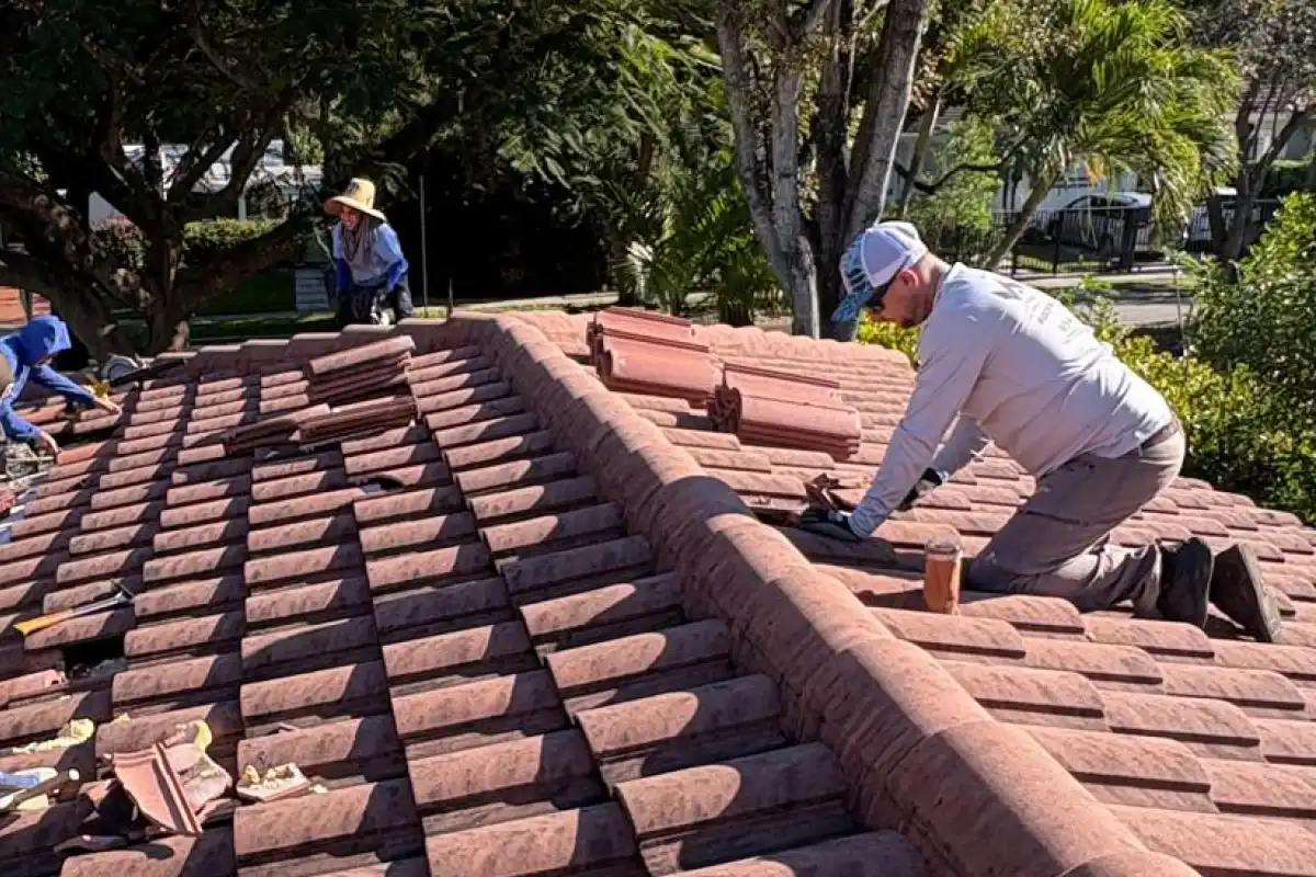 Weather Recovery Solutions performing a precision tile roof repair in The Roads neighborhood of Miami-Dade County, ensuring compliance with High-Velocity Hurricane Zone (HVHZ) standards.